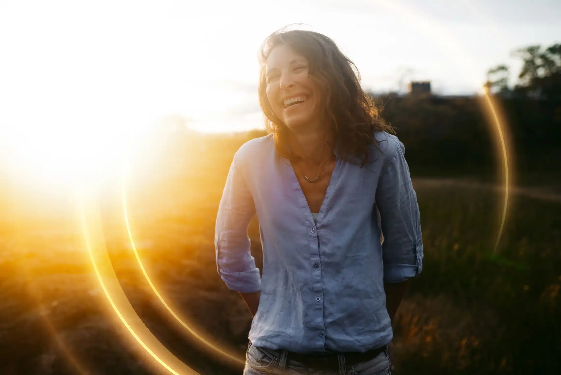 Happy Woman standing outside with sunburst flare-with Golden bubble (1)