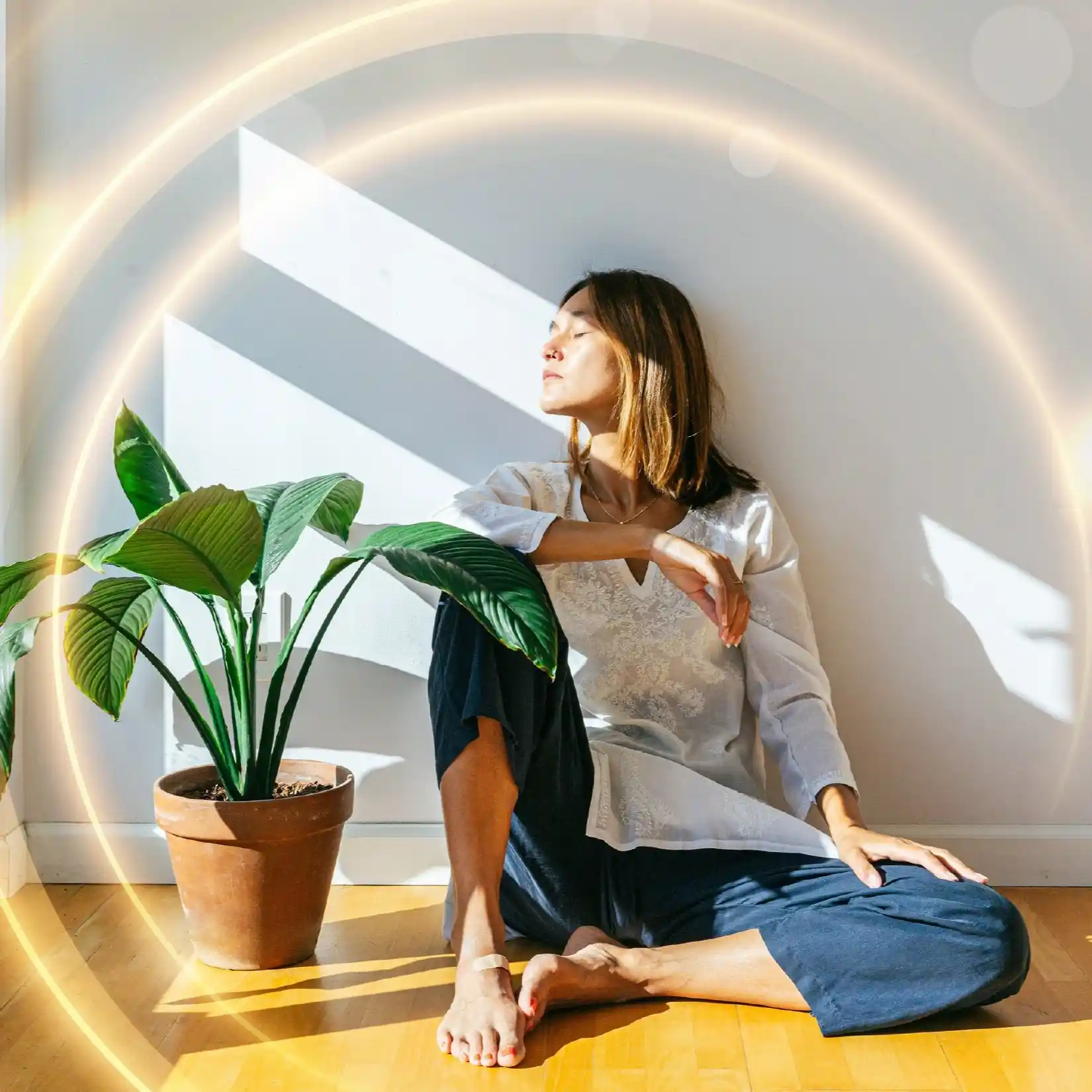 Woman sitting on floor in sun-small-square Woman meditating in the FLFE Field.